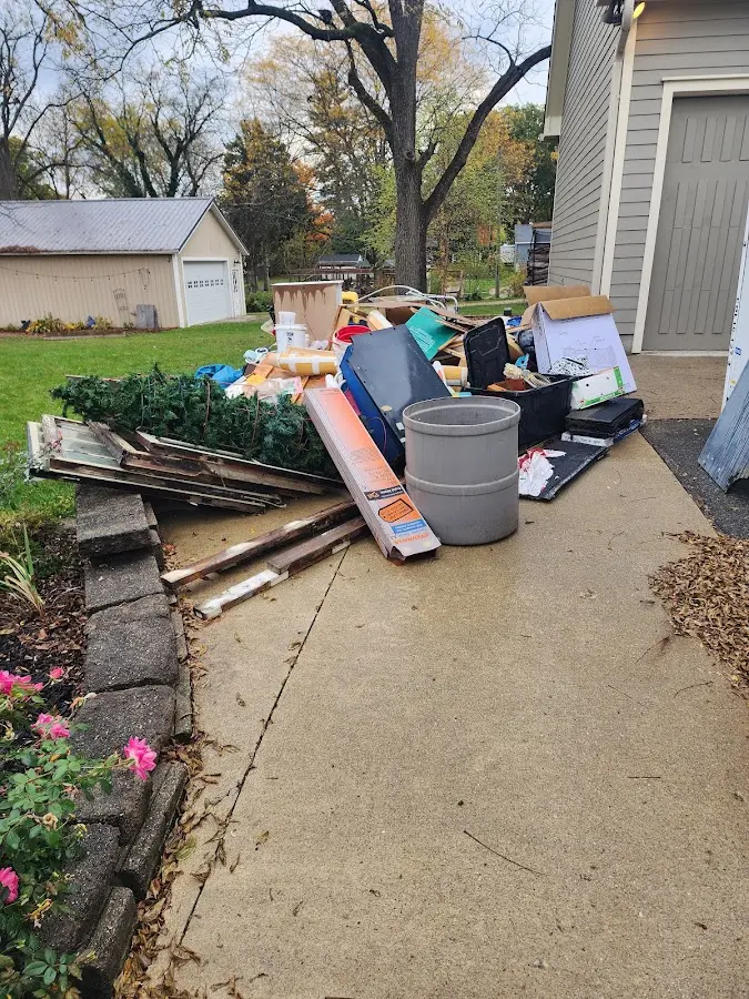 Dumpster being loaded with debris for Estate Cleanout Dumpster Rental in Saddle River